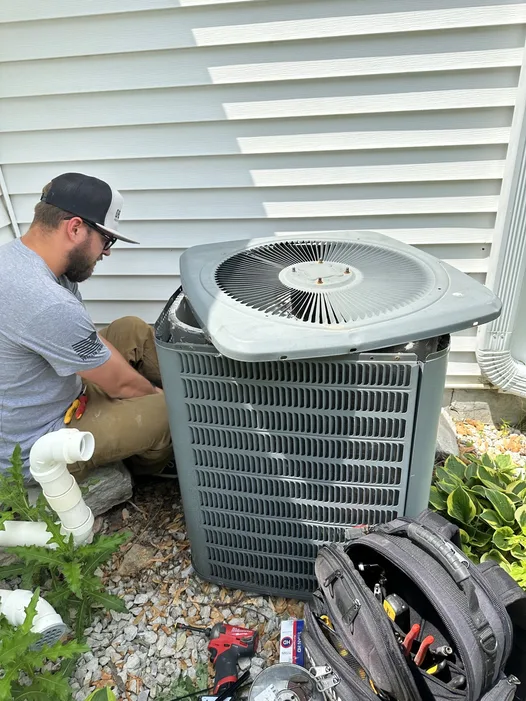 Obsidian technician diagnosing and repairing an outdoor AC condenser